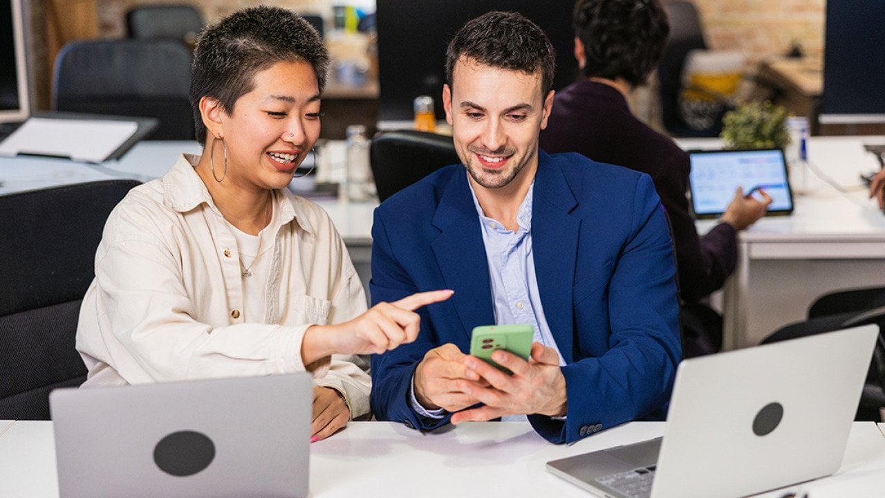 A diverse business team working together on a project in an office.