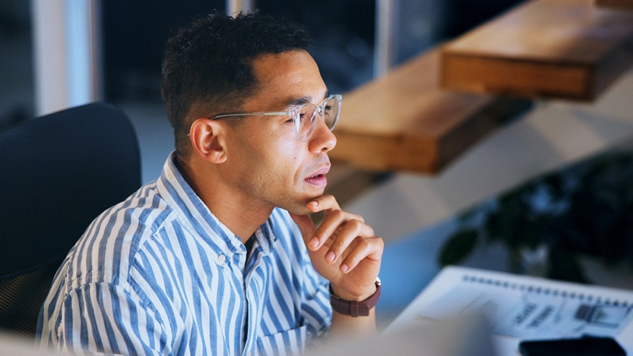 A focused businessman working at night in an office.