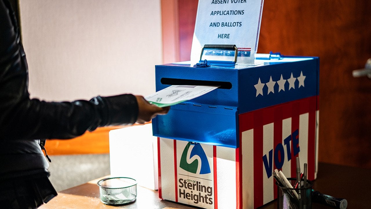 A voter casting an absentee ballot at the Sterling Heights Election Center in Michigan, USA.