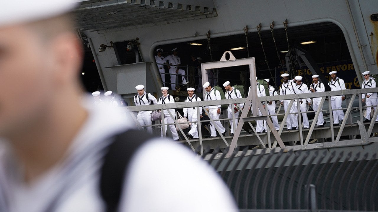 Sailors disembark from the USS Carl Vinson after returning from deployment to their homeport at Naval Air Station North Island in Coronado, California.
