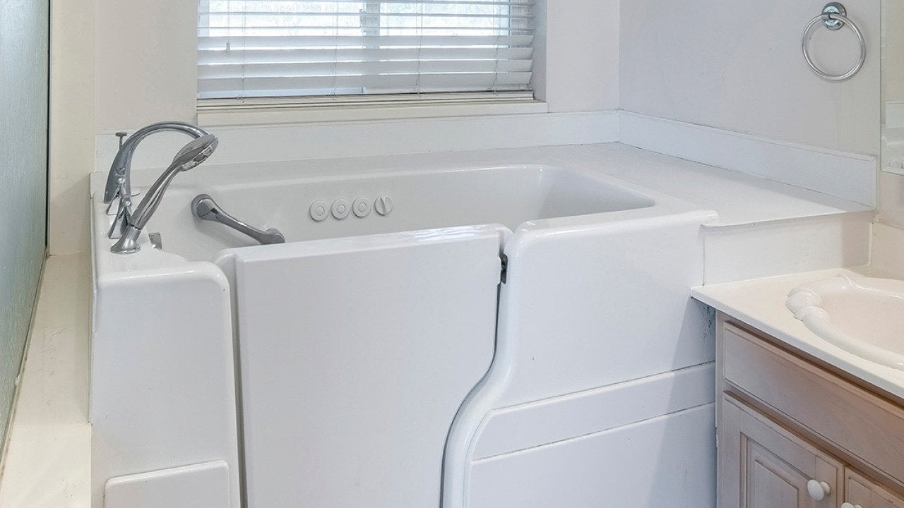 A square walk-in bathtub with elderly and handicapped accessibility.