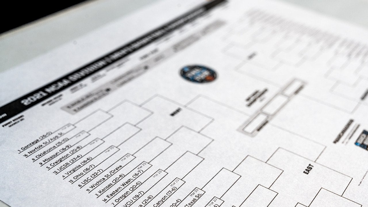 A selective focus shot on the Western Region part of a printed NCAA tournament bracket.