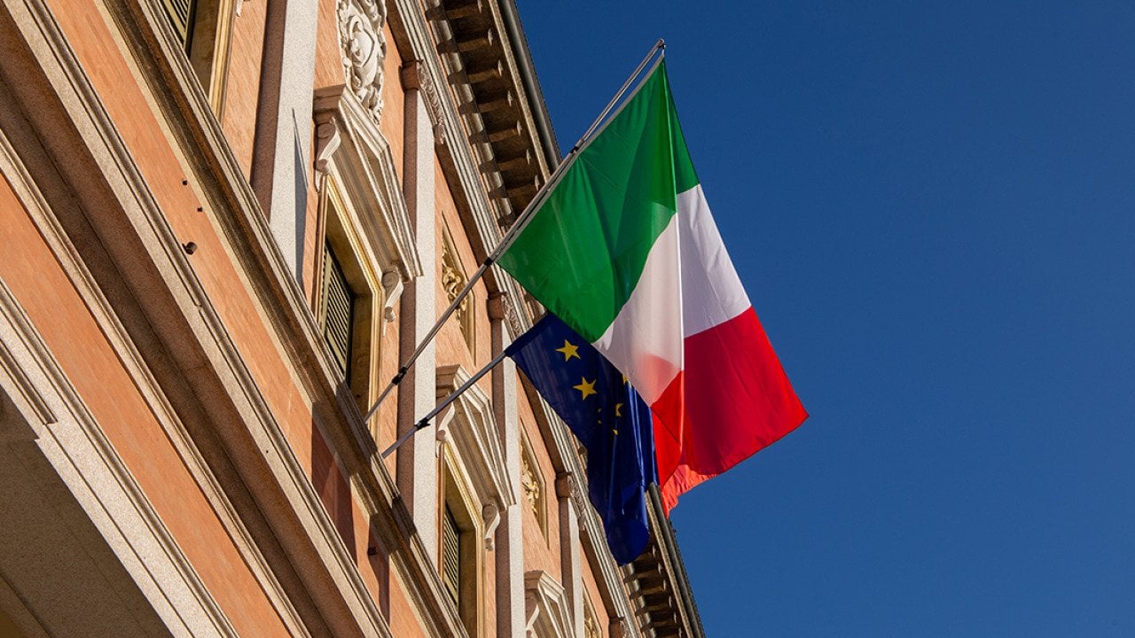 Italy and European Union flags on a balcony of a building in Reggio Emilia City, Italy. 