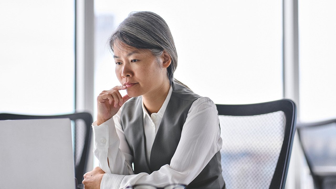 A business manager reviewing work tasks in an office.