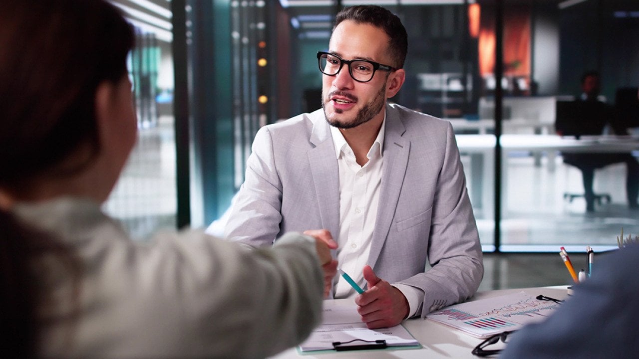 A tax advisor shaking hands with a client.