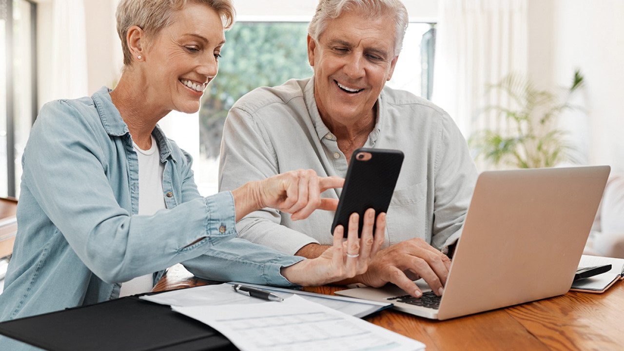 An elderly couple working on their retirement documents at home.