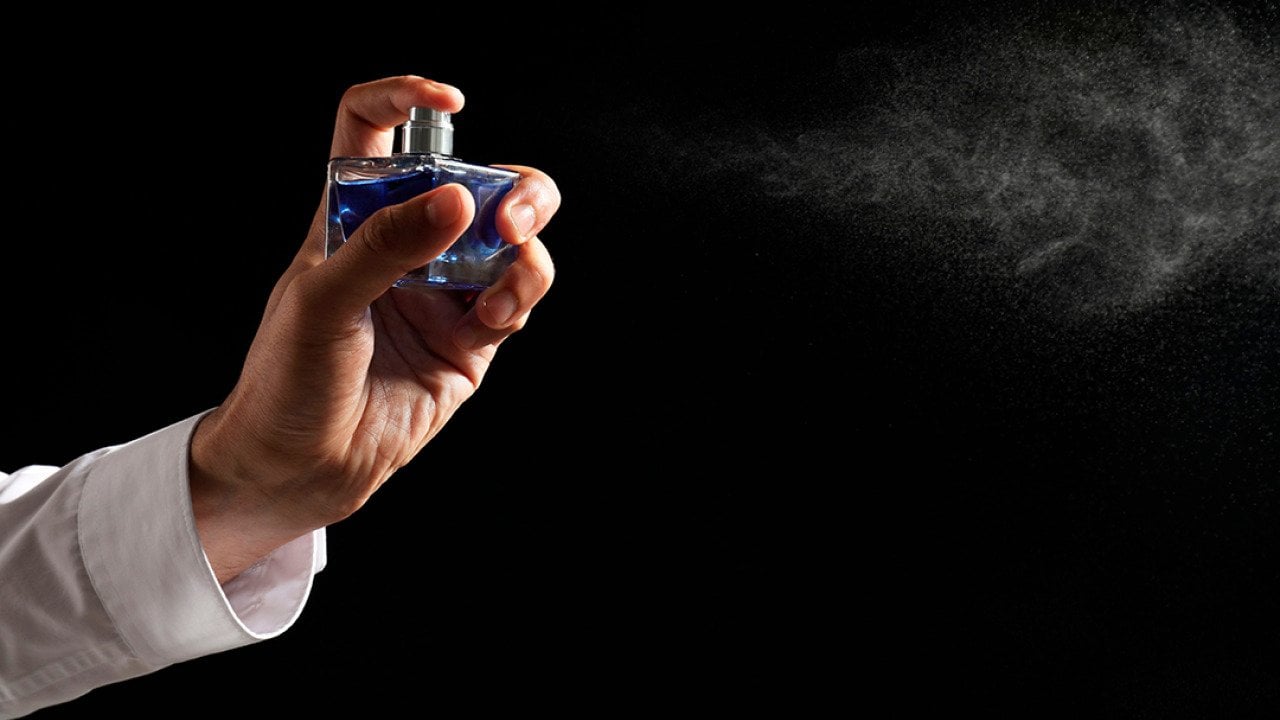 Luxury perfume being sprayed in the air.