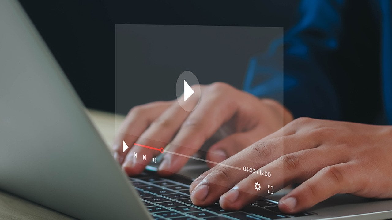 Graphic of a YouTube video screen over a person using a laptop.
