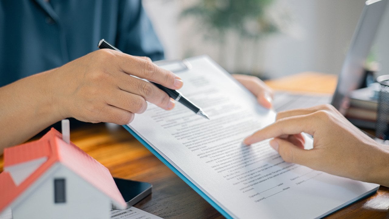 Broker showing a client a contract.