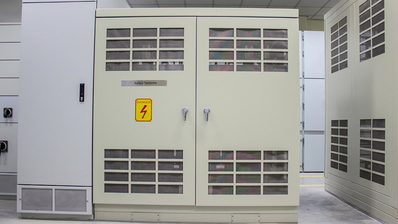 A dry type transformer installed in an electrical room from a power plant.