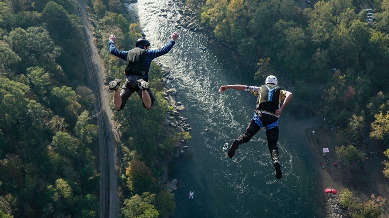 Two jumpers leap from New River Gorge Bridge in West Virginia.