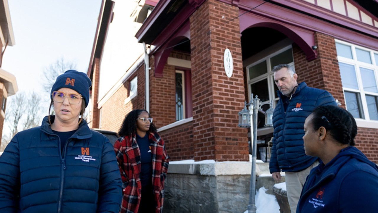 Members of Ohio's Hamilton County Quick Response Team, which helps people who use fentanyl get treatment, stand outside a brick home with snow on the ground. Ohio had the largest drop in opioid overdose deaths of any state as of October 2025.