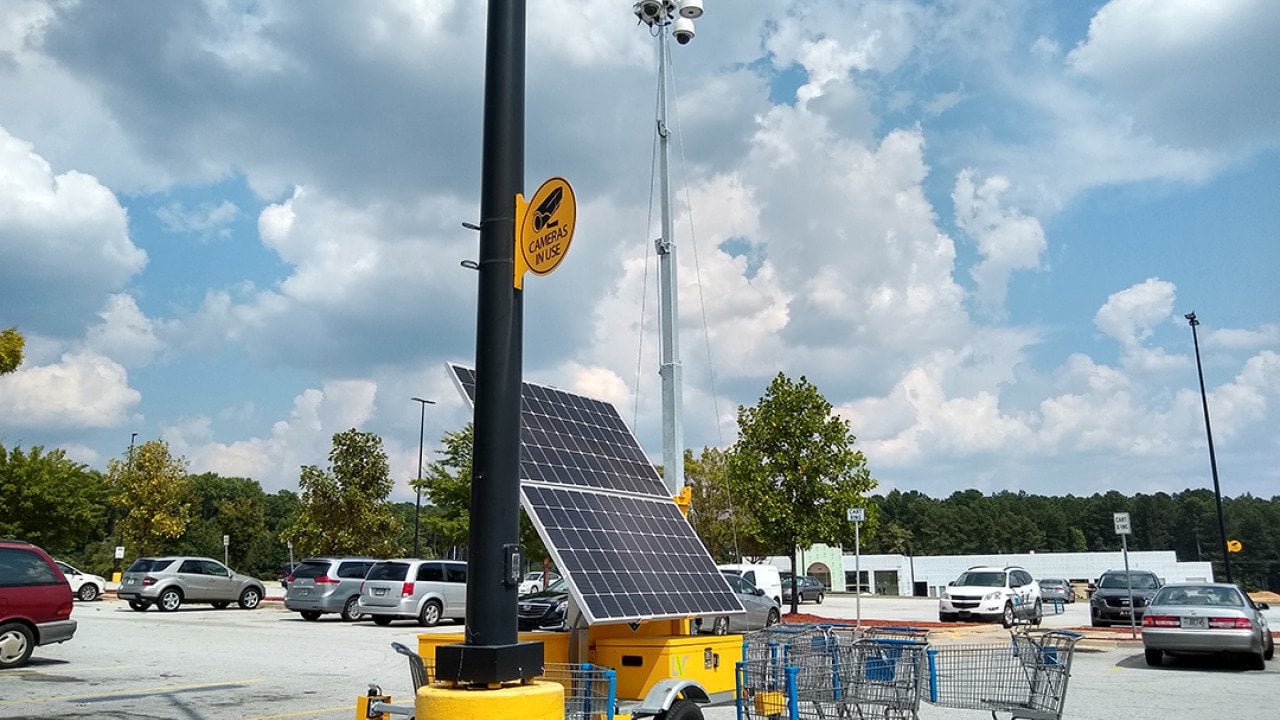 A solar powered surveillance system in a shop's parking lot in Atlanta, Georgia.