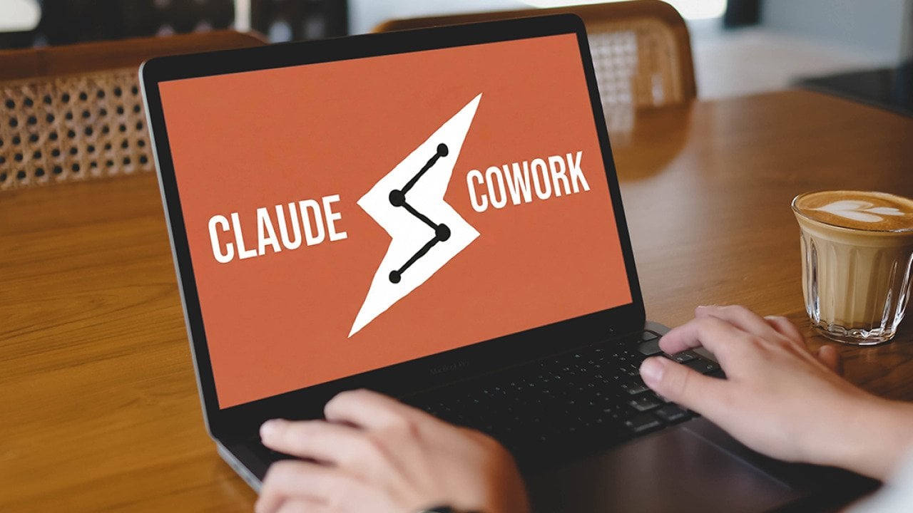 A person using the Claude Cowork platform while working at a cafe.