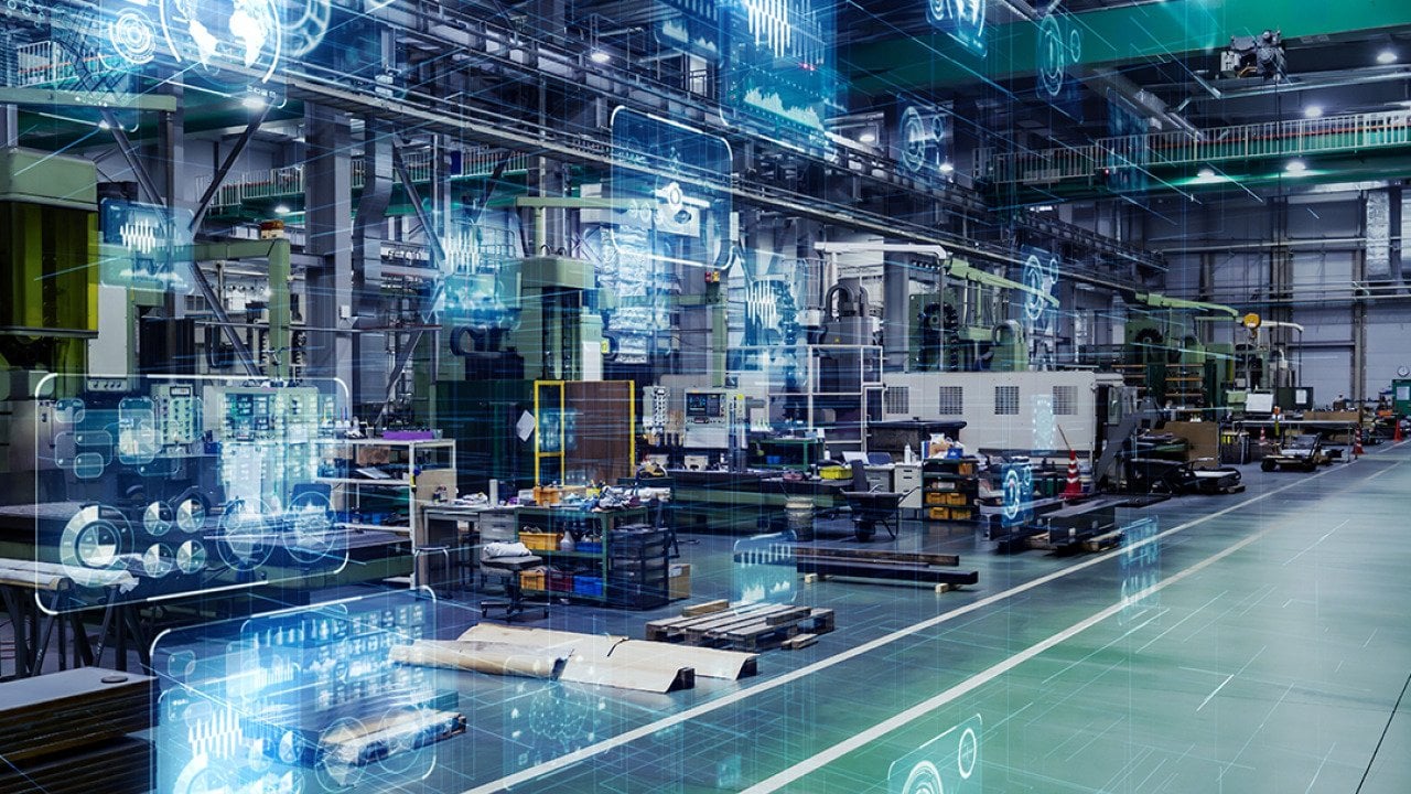 Large digital machines and tools inside a manufacturing warehouse.