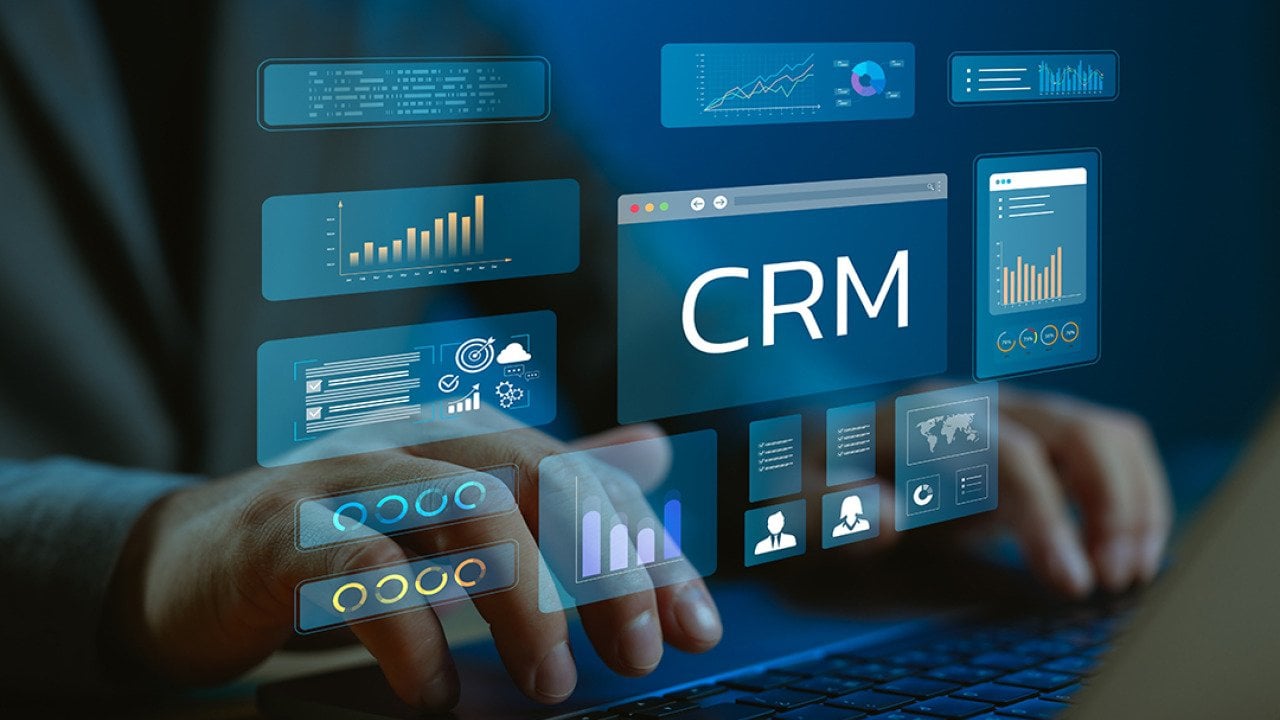 A data analyst utilizing CRM (Customer Relationship Management) system and dashboard from a work laptop.
