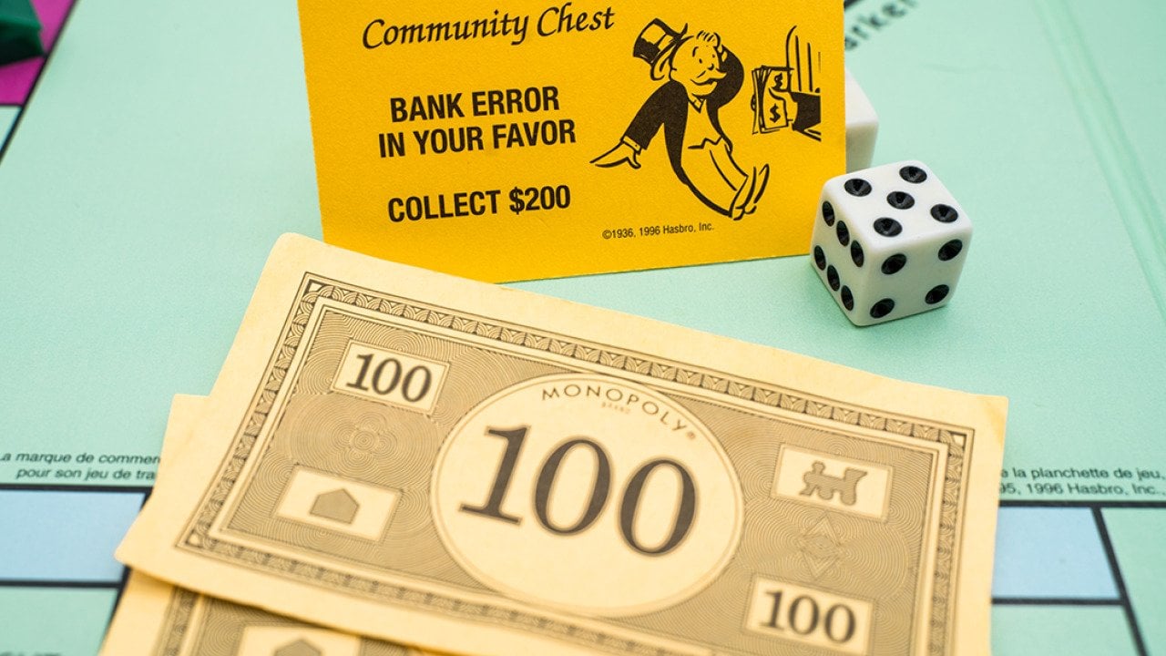 Banknotes and a bank error card from the Monopoly board game.