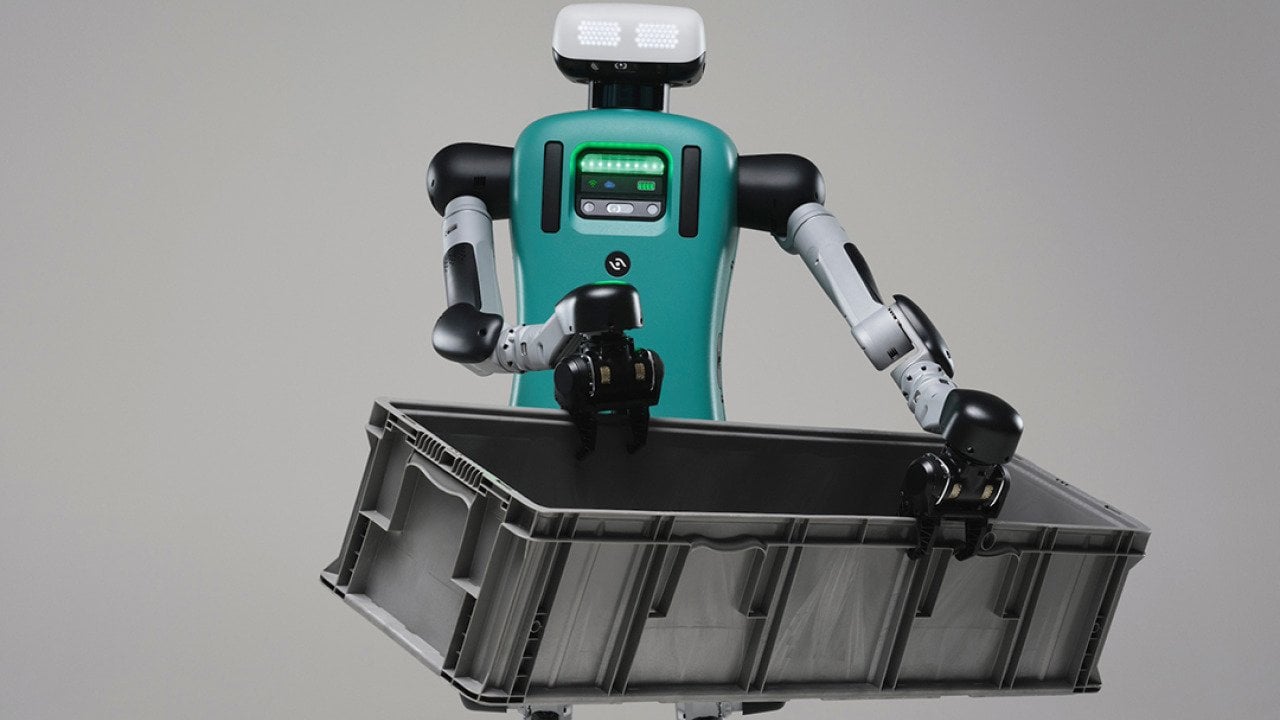 Digit the robot carrying a black crate.