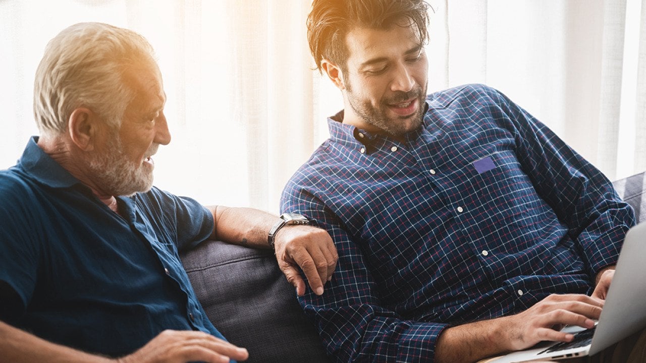 A senior father with his adult son discussing matters at home.