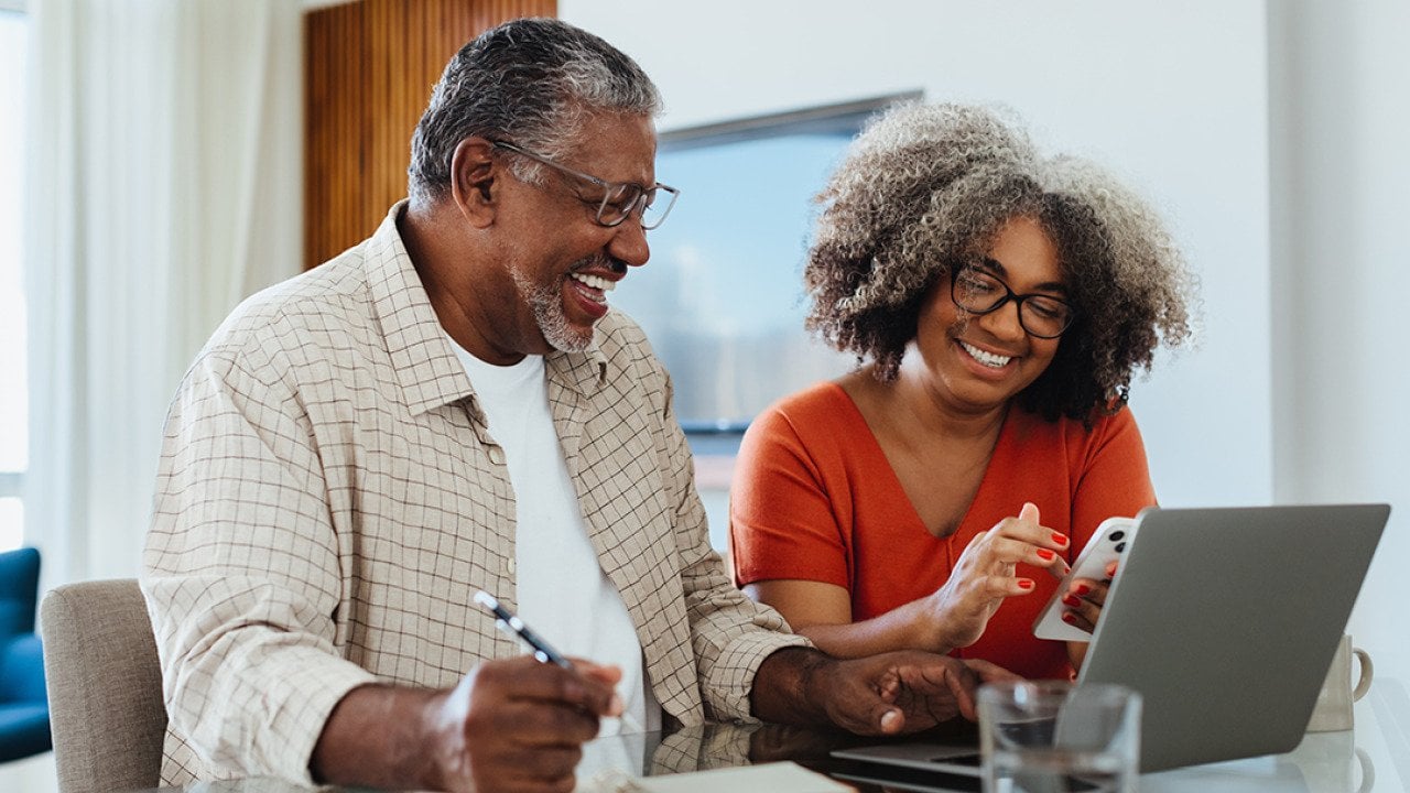 An elderly couple planning their budget and finances at home.