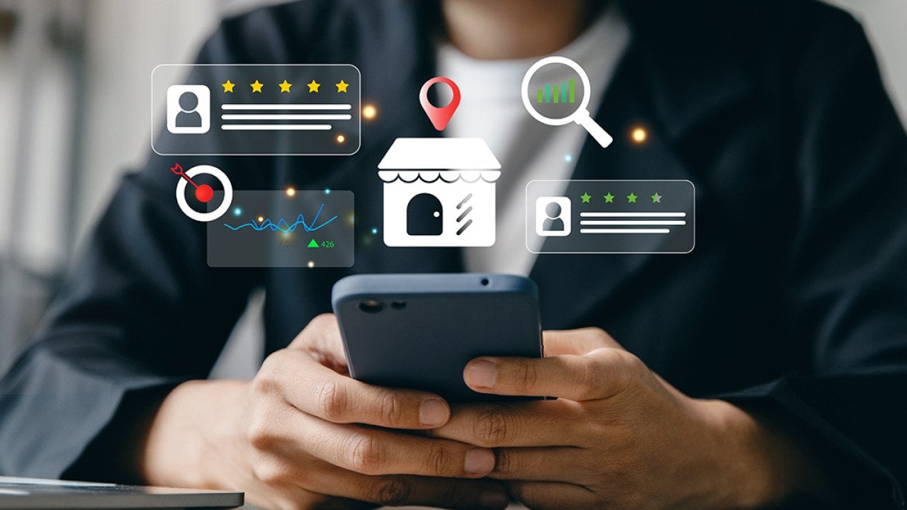 Businesswoman using a phone and illustrated with local SEO insight graphics.