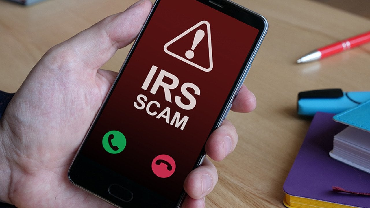 An Internal Revenue Service (IRS) scam call is displayed from a smartphone.