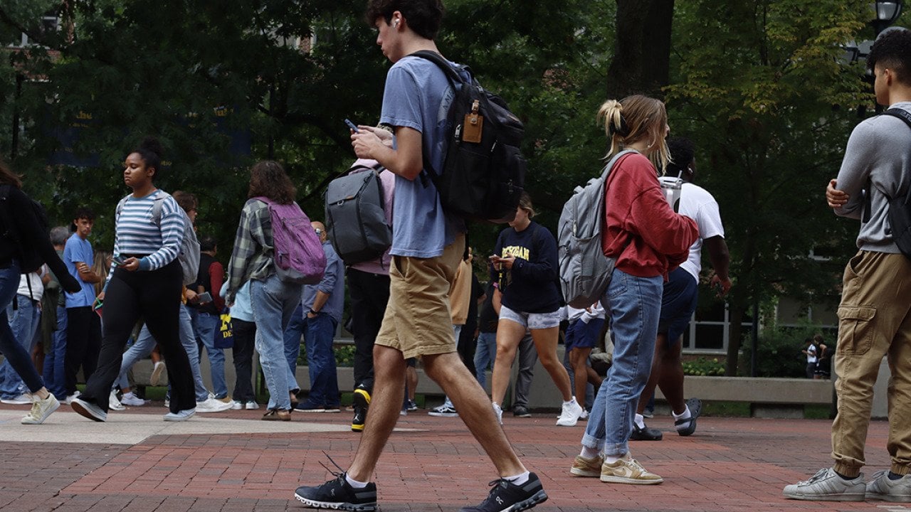 Students walking to their classes in a university town in Ann Arbor, Michigan, USA.