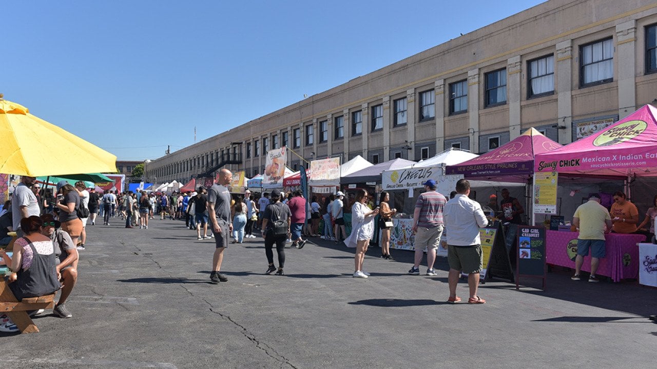 A lane of vendors during Smorgasburg LA, a Sunday outdoor food and shopping market event in California.
