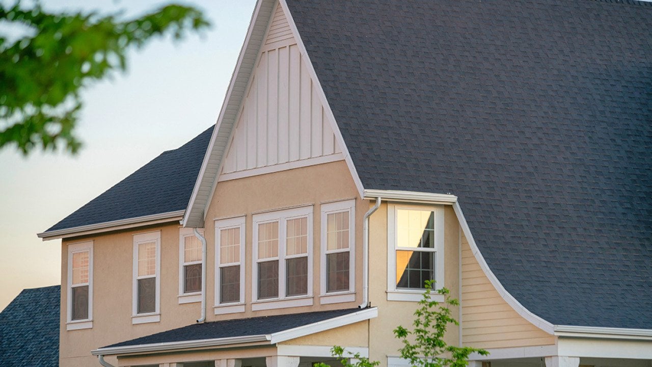 A two-story residential house with gray roofing.