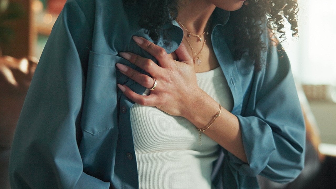 A young woman experiencing chest pain.