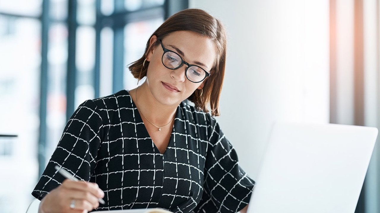 An office employee drafting a proposal for a stakeholder organization.