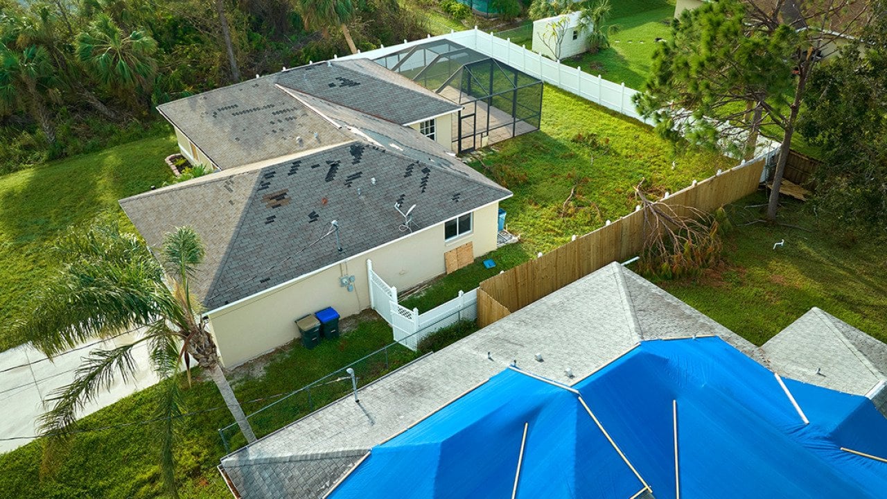 Aerial view of a house's roof damaged by Hurricane Ian in Florida.