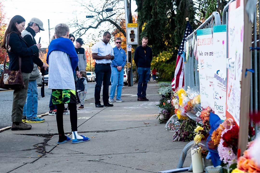 People gathering and paying their respects at a memorial, one year after the shooting at the Tree of Life synagogue in Squirrel Hill, Pittsburgh, USA.