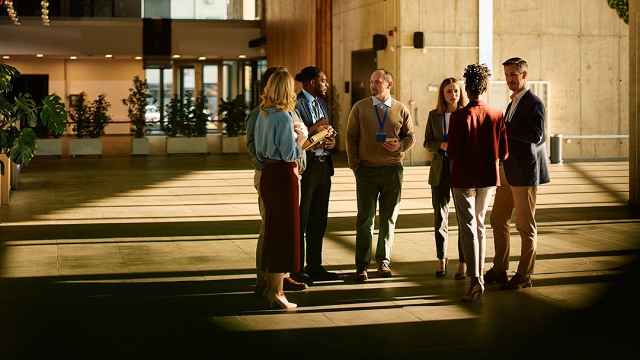 A group of entrepreneurs engaged in discussion at a conference venue.