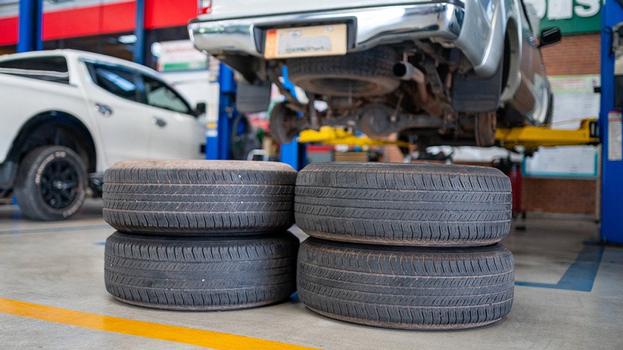 A stack of used tires in an auto repair shop.