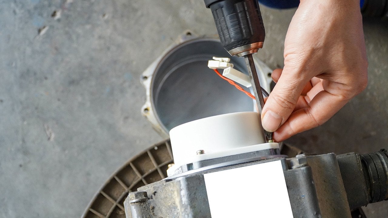 A repairman removing servo electric motor in a workshop.