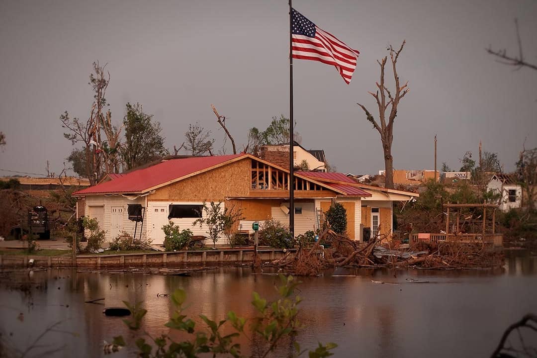 A new American flag pole standing outside a damaged Forest Lake house after the 2011's EF4 tornado in Tuscaloosa, Alabama.
