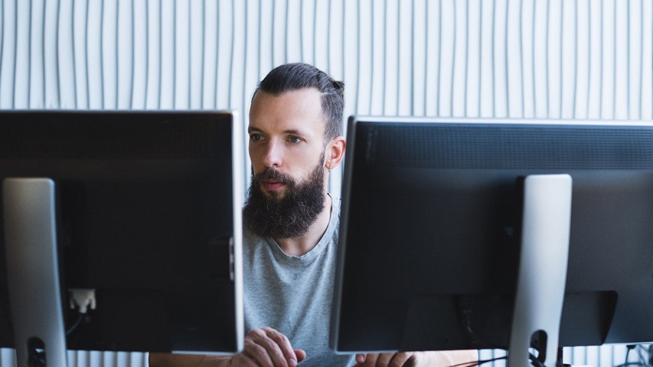 A software engineer working on a quality assurance task in an office.