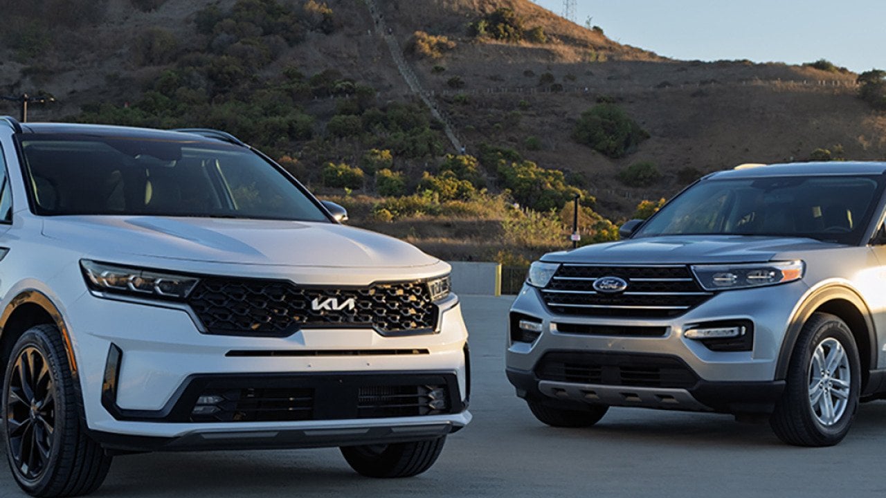 Ford Explorer and Kia Sorento cars parked outdoors.