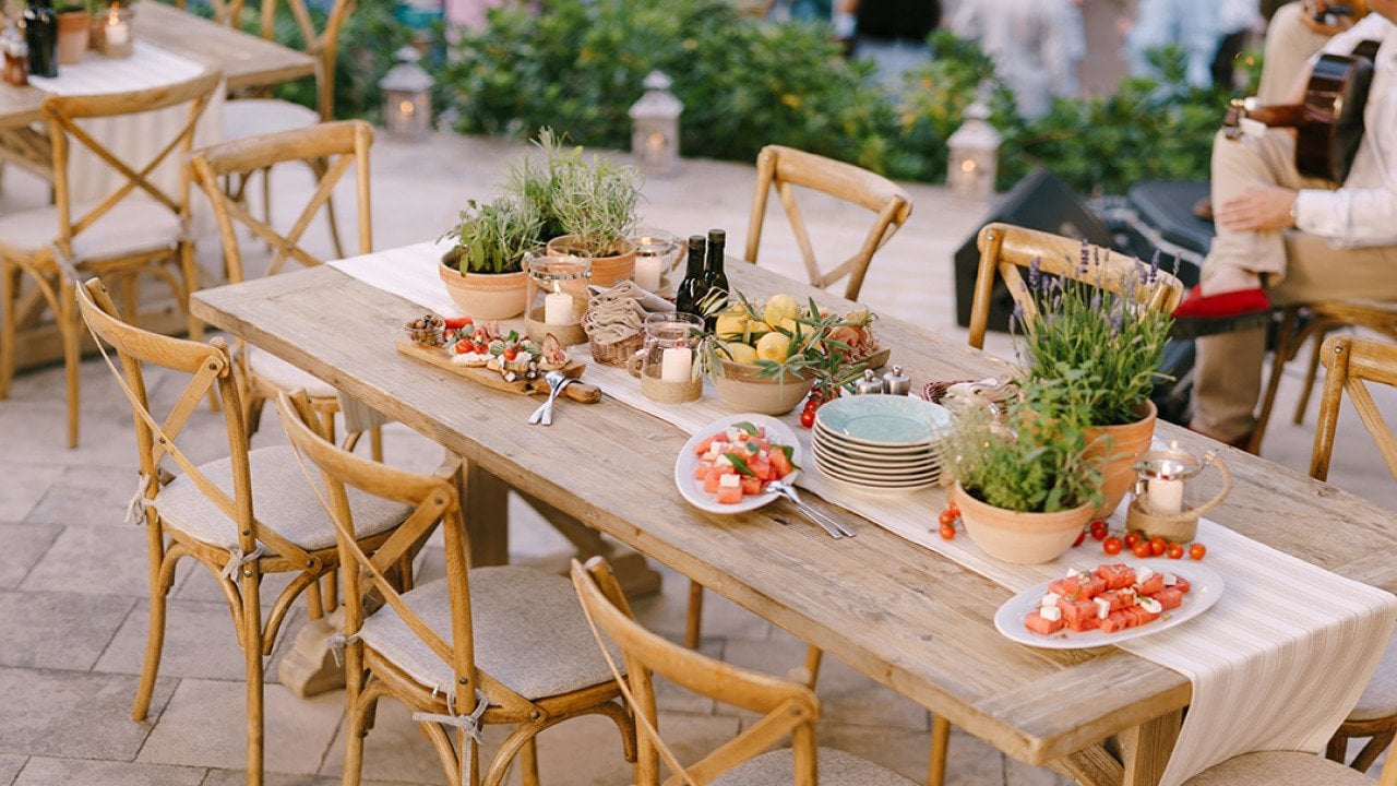 Decorated tables arranged for a rustic wedding dinner.