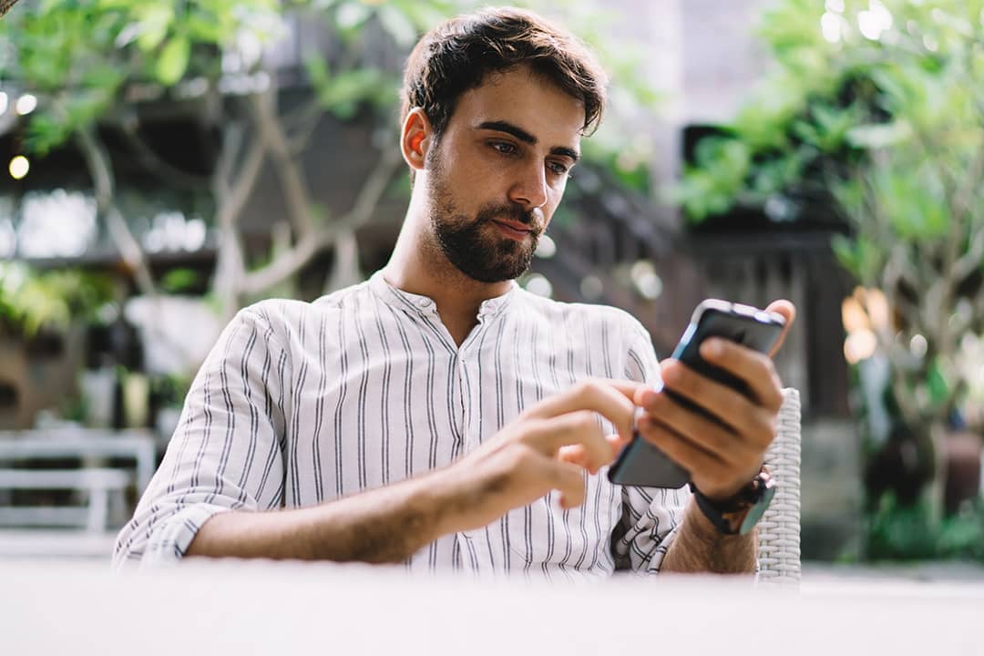 A young businessman browsing information on his phone.