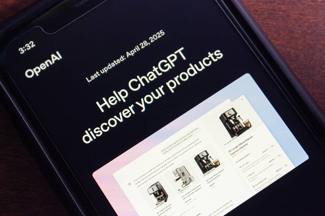 Close-up of a smartphone screen showing OpenAI's website with the ‘Help ChatGPT discover your products’ page.