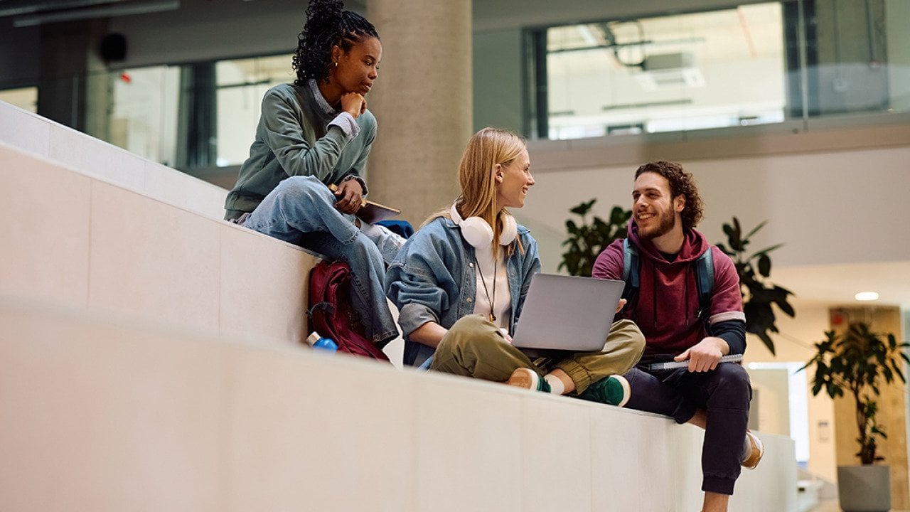 A diverse group of university students having a discussion in campus.
