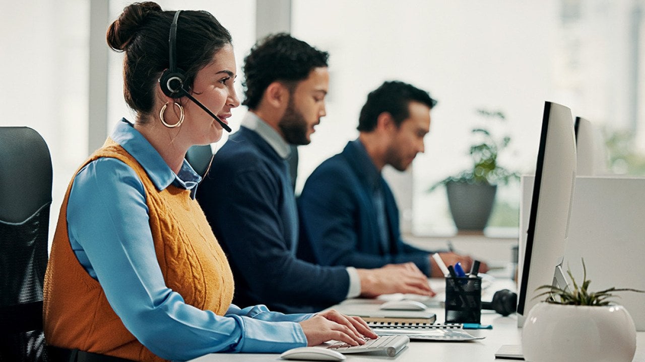 A call center employee talking with a customer over a call for solution support.
