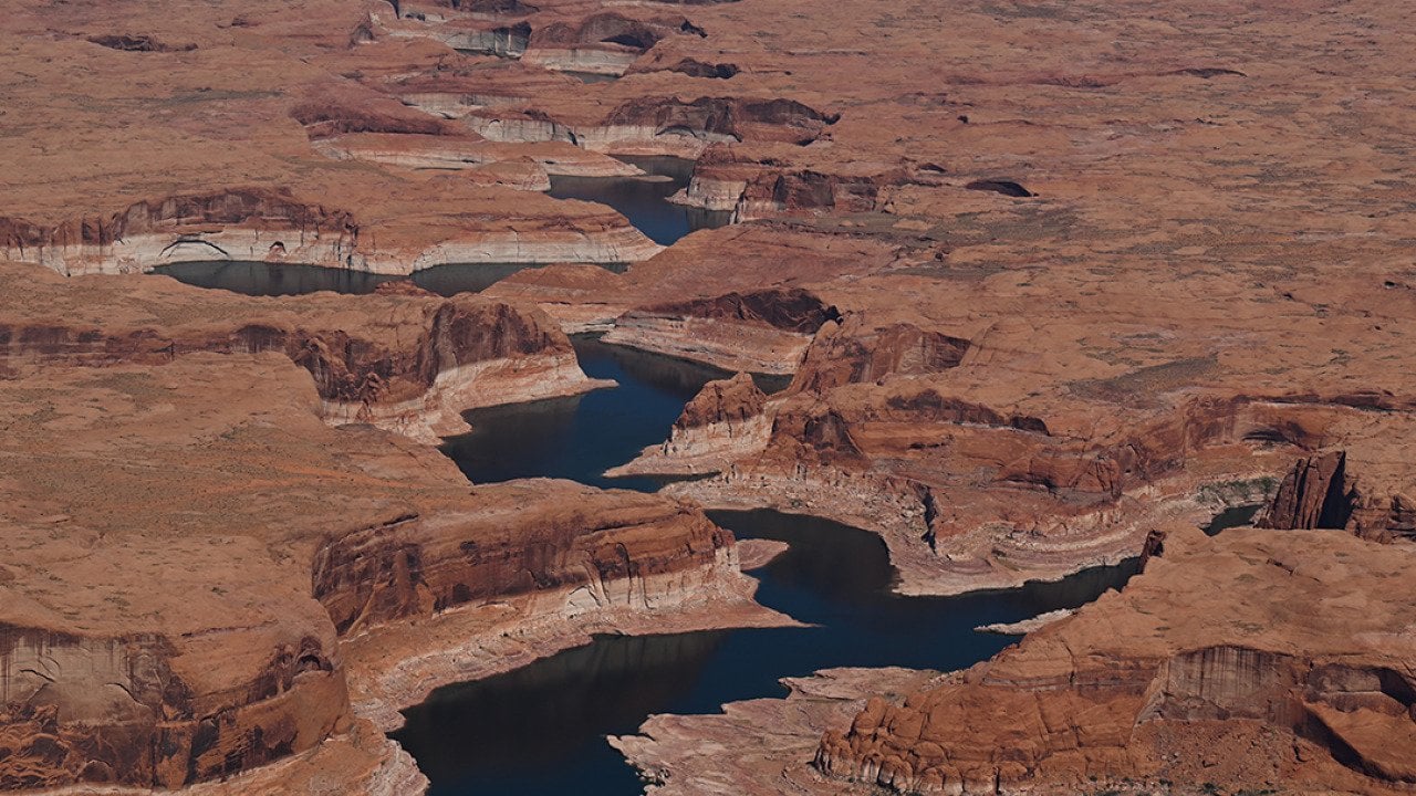 A bathtub ring marks the receded shoreline at Lake Powell, where water levels remain low in Glen Canyon National Recreation Area on April 30, 2026, near Big Water, Utah. 