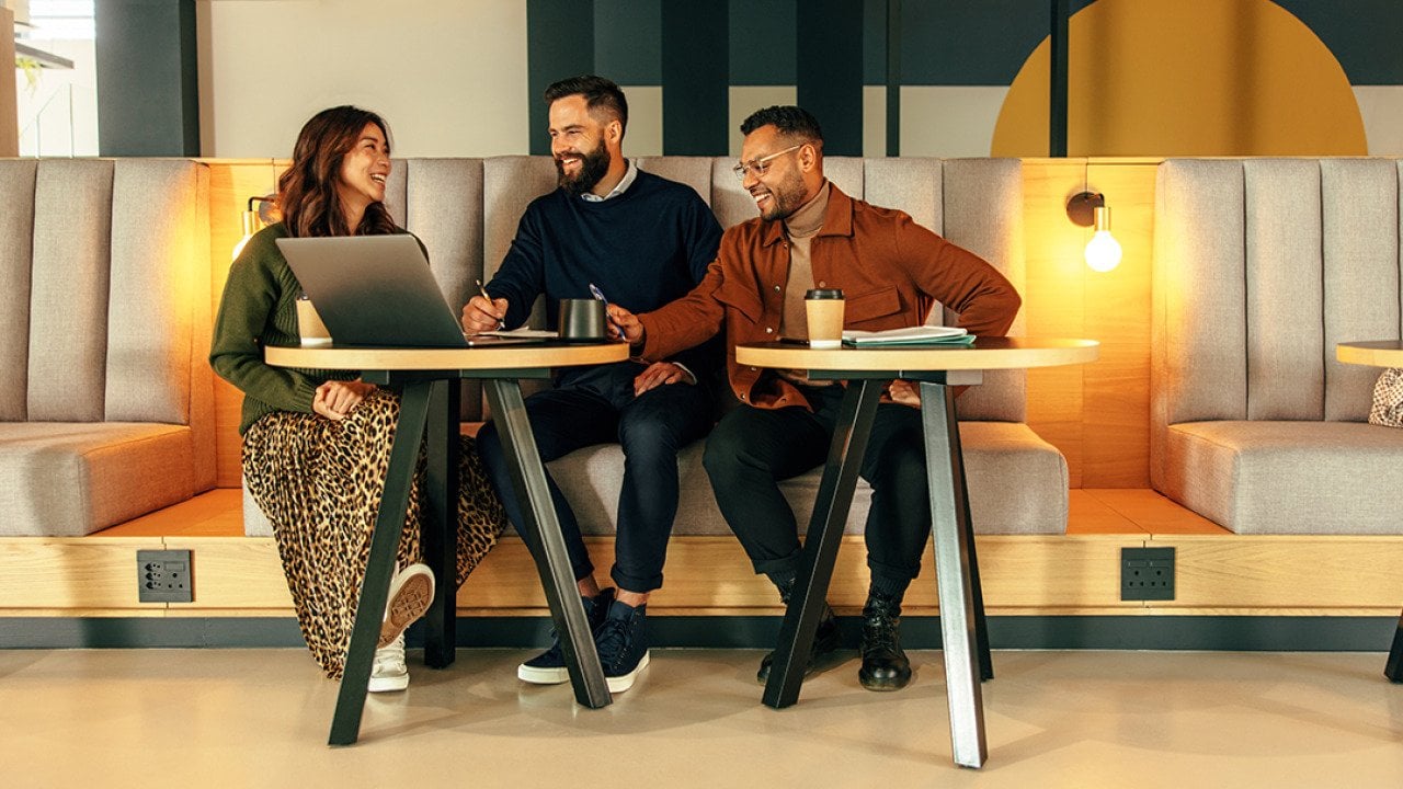 A group of young entrepreneurs working together in a lobby.