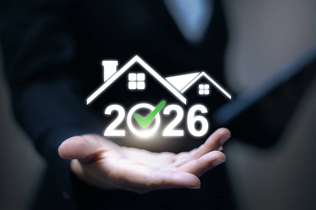 A real estate professional gesturing to hold a 2026 housing graphic illustration.