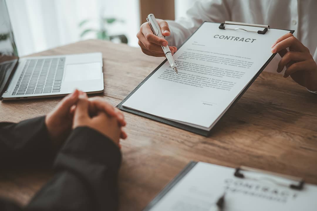 A business partner explaining agreements and matters from a contract to her co-partner.