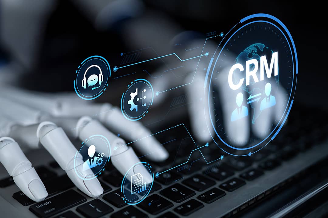 A robot enhancing CRM automation analytics and tools with artificial intelligence from a laptop.