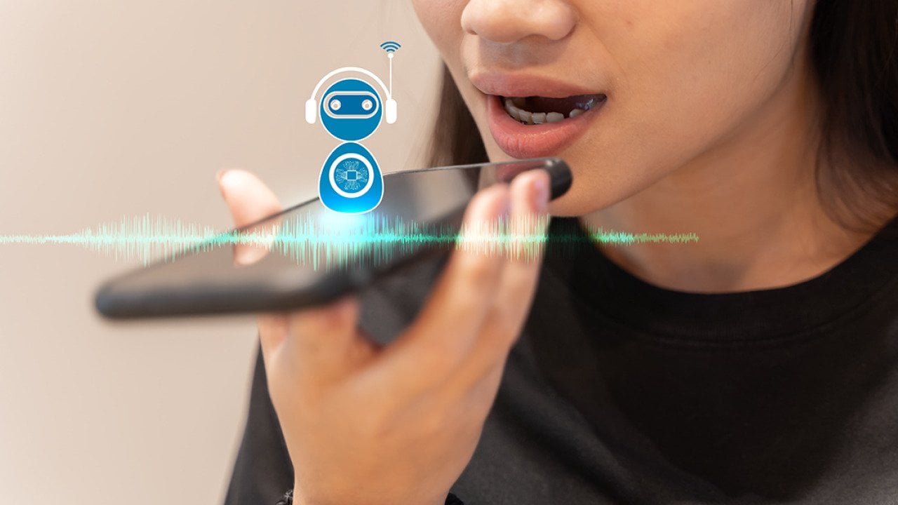 A young woman talking into a smartphone with AI voice assistance.